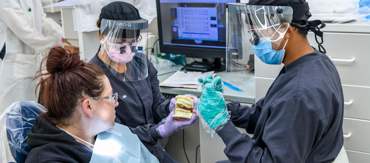 Dental hygiene student working on a patient